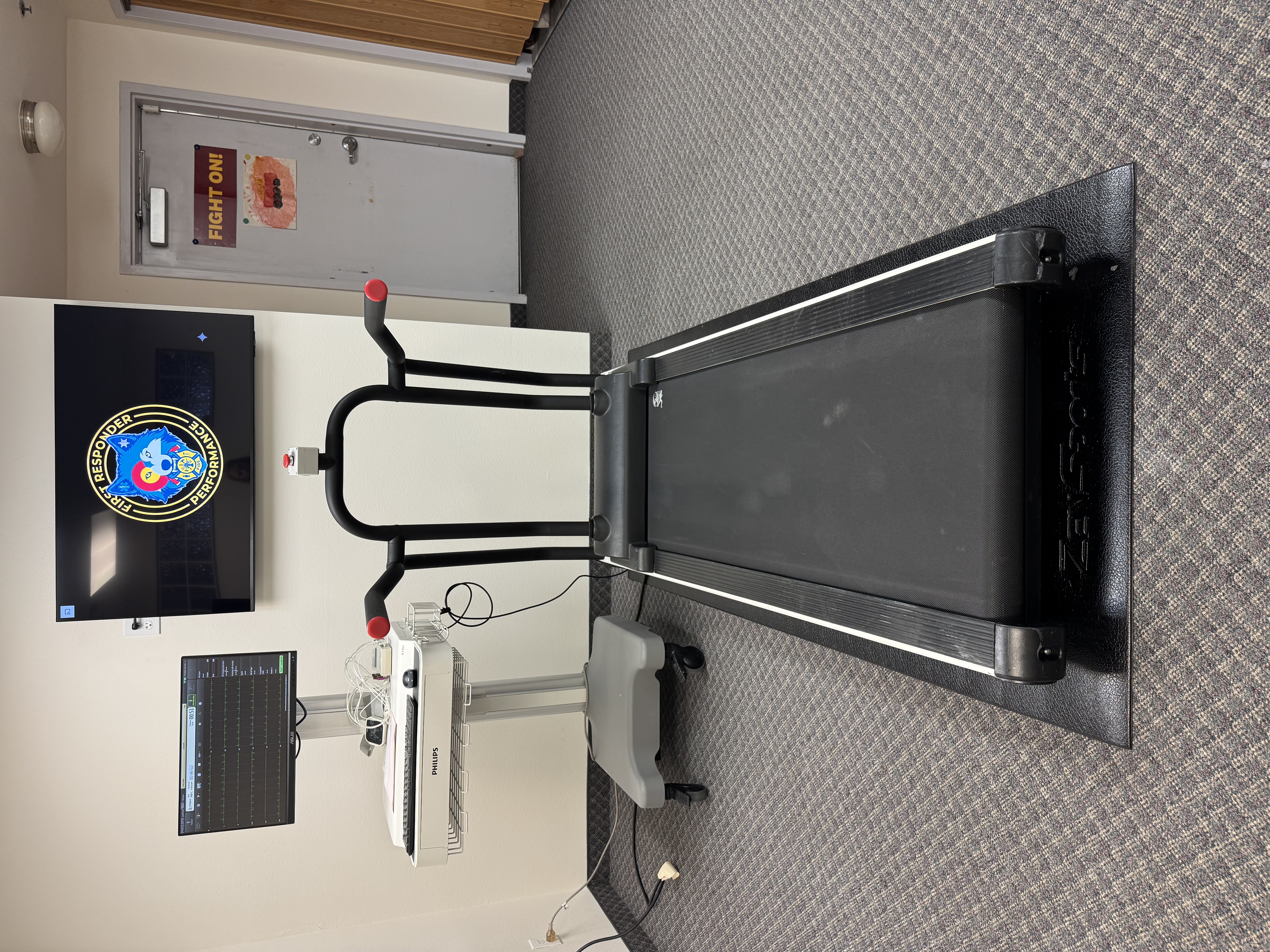 Our testing space — treadmill, ECG equipment, and First Responder Performance display